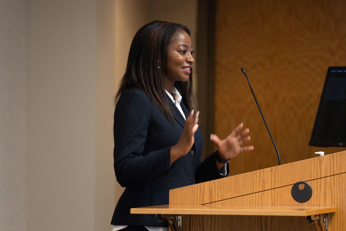 Female presenter standing at the podium at the 2023 SOPH Research Day